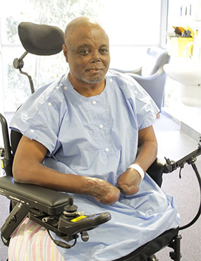 Edwin Ocha Ikwu, a smiling man in a wheelchair.