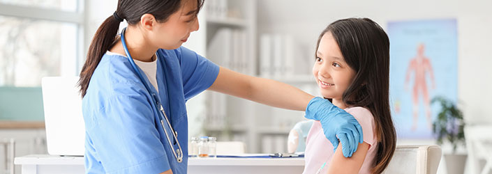 A nurse immunising a young girl, at the clinic